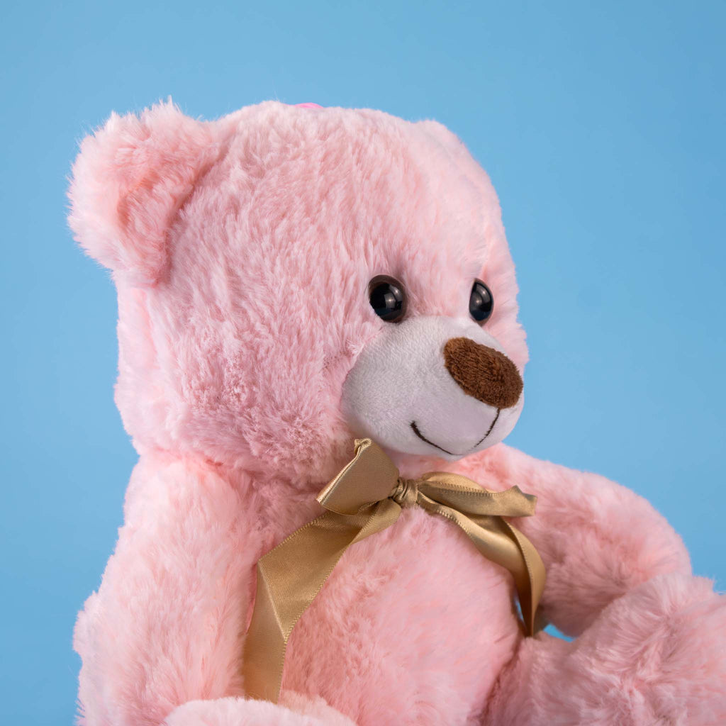 Oso de peluche color rosa con moño decorativo, ideal para regalos, baby showers o eventos.