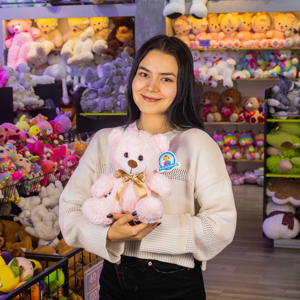 Osos de peluche color rosa con moño dorado. Peluches al mayoreo