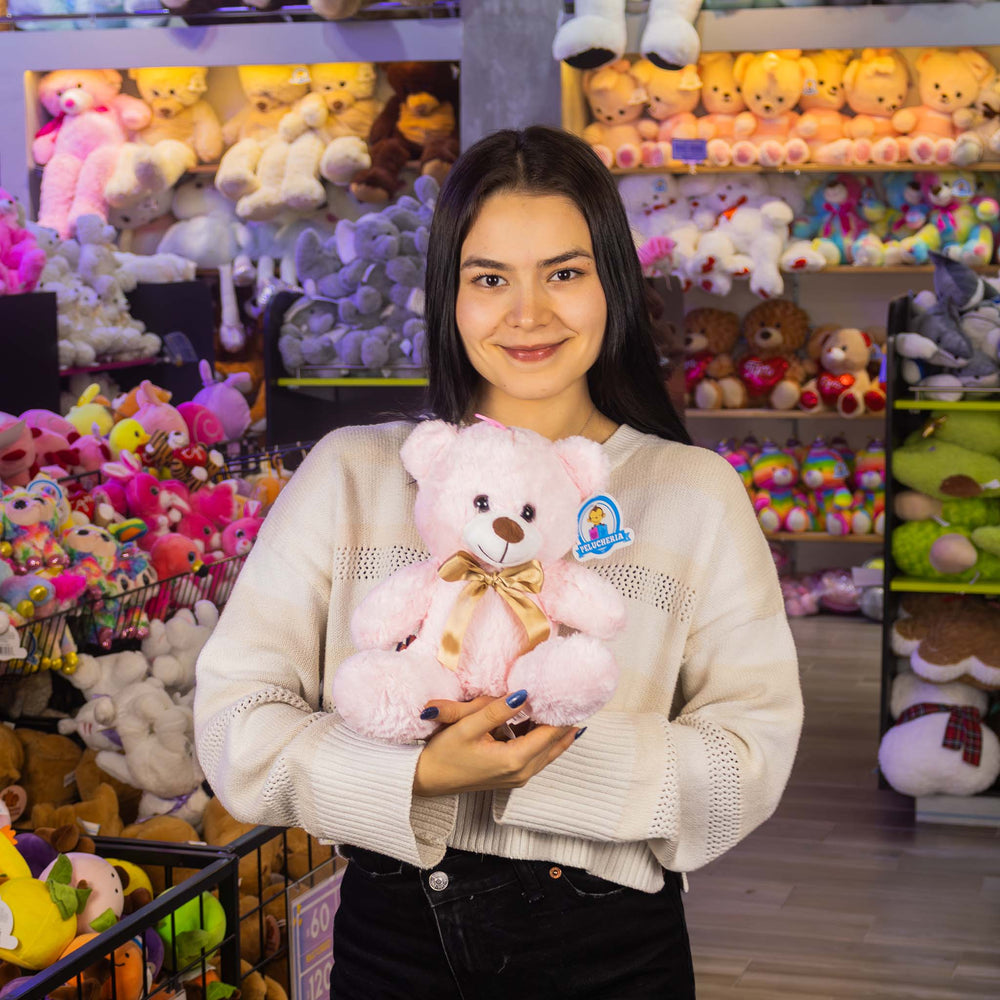 Osos de peluche color rosa con moño dorado. Peluches al mayoreo