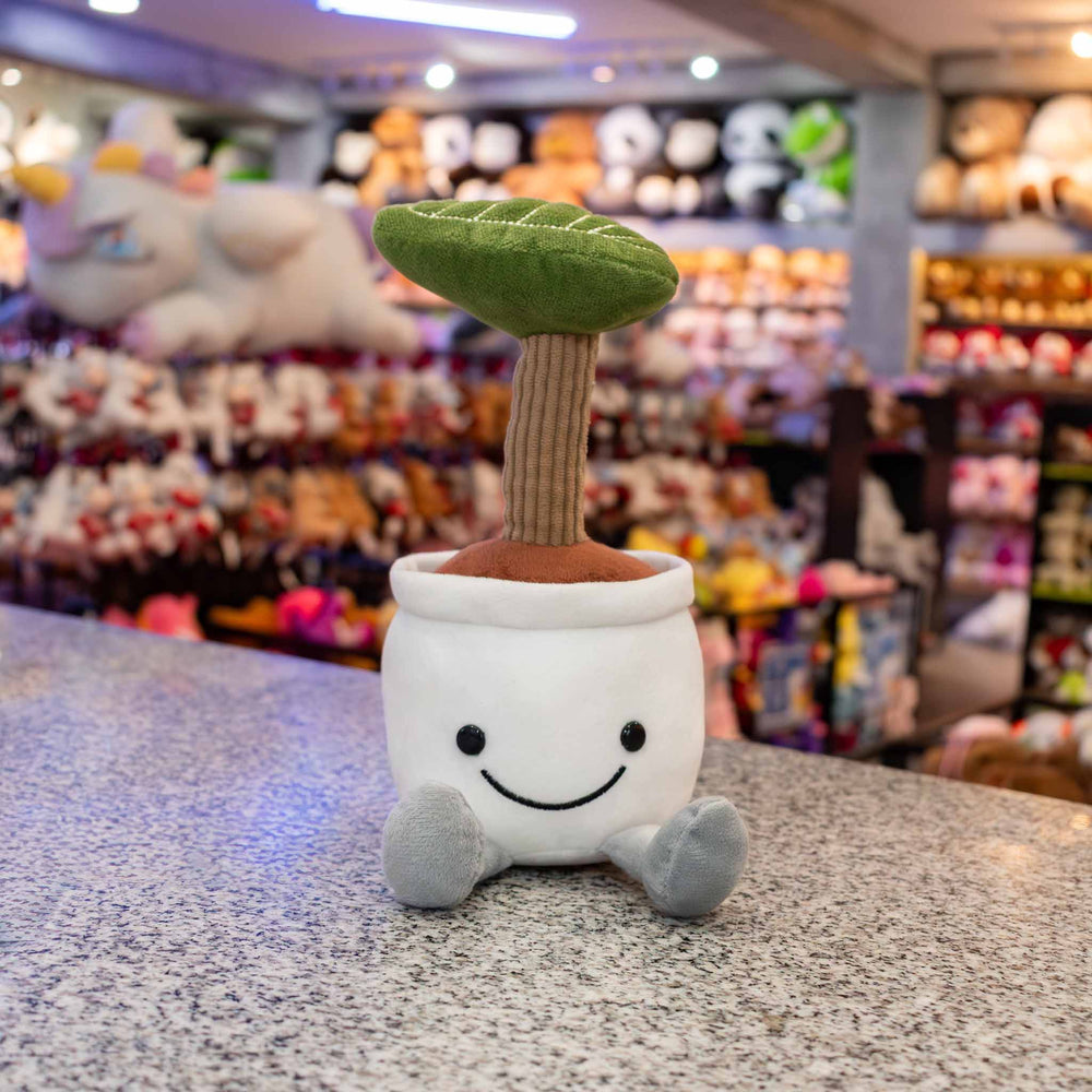 Planta de peluche Kumba 23 cm PIUINIKI - Pelucheria. Peluche de planta con carita feliz en color verde
