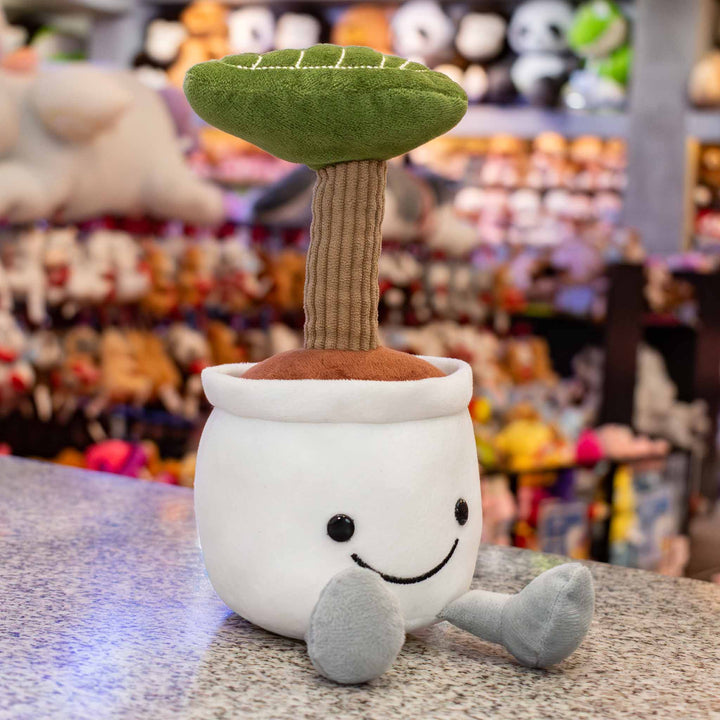 Planta de peluche Kumba 23 cm PIUINIKI - Pelucheria. Peluche de planta con carita feliz en color verde