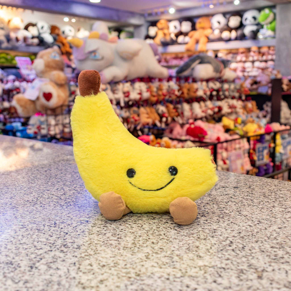 Plátano de peluche Nana 18 cm PIUINIKI, color amarillo con carita feliz