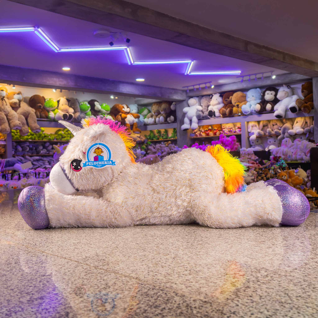 Unicornio de peluche gigante, color blanco con detalles brillantes. Ideal para tiendas de regalos y mayoristas